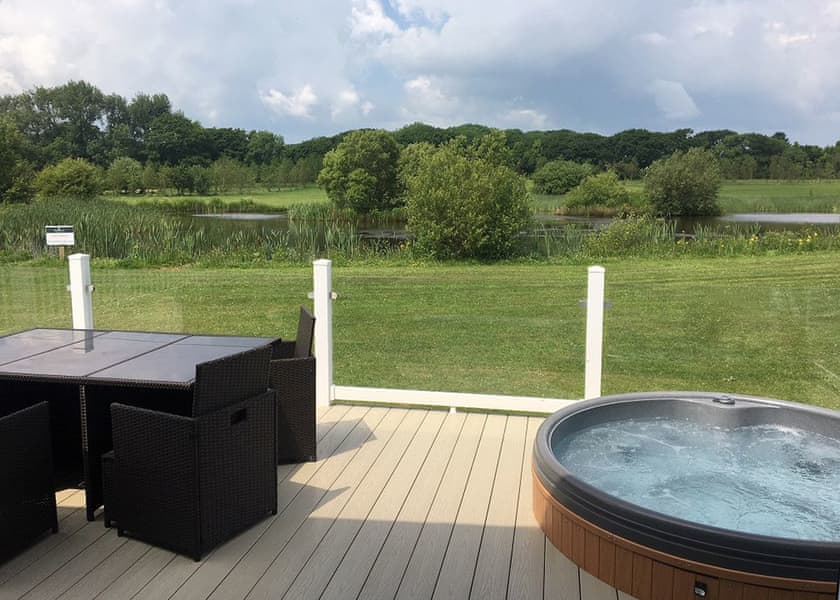 Lake view and sunken hot tubs at Florence Springs Luxury Lodge breaks, Tenby, Pembrokeshire, South West Wales