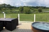 Lake view and sunken hot tubs at Florence Springs Luxury Lodge breaks, Tenby, Pembrokeshire, South West Wales