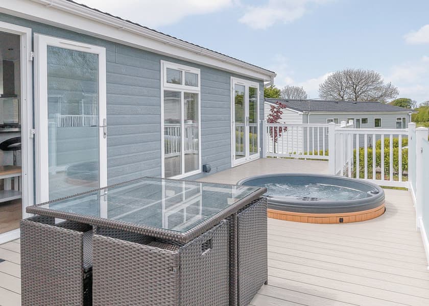Private decking with sunken hot tubs at Florence Springs Luxury Lakeside Lodges - Tenby, Pembrokeshire, South Wales