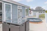 Private decking with sunken hot tubs at Florence Springs Luxury Lakeside Lodges - Tenby, Pembrokeshire, South Wales
